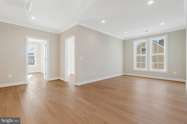 unfurnished living room with crown molding and light hardwood / wood-style floors