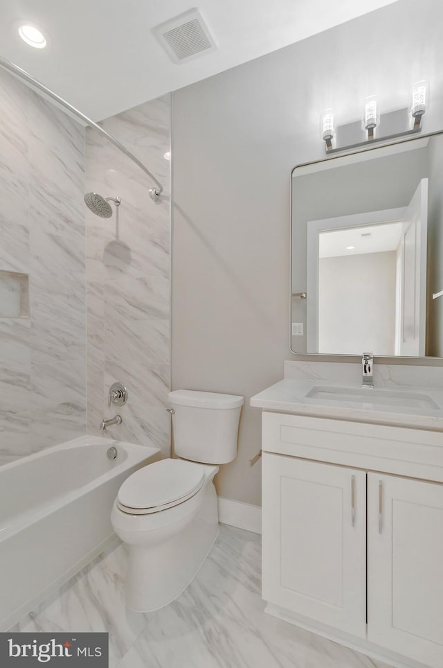 full bathroom featuring toilet, tiled shower / bath, and vanity