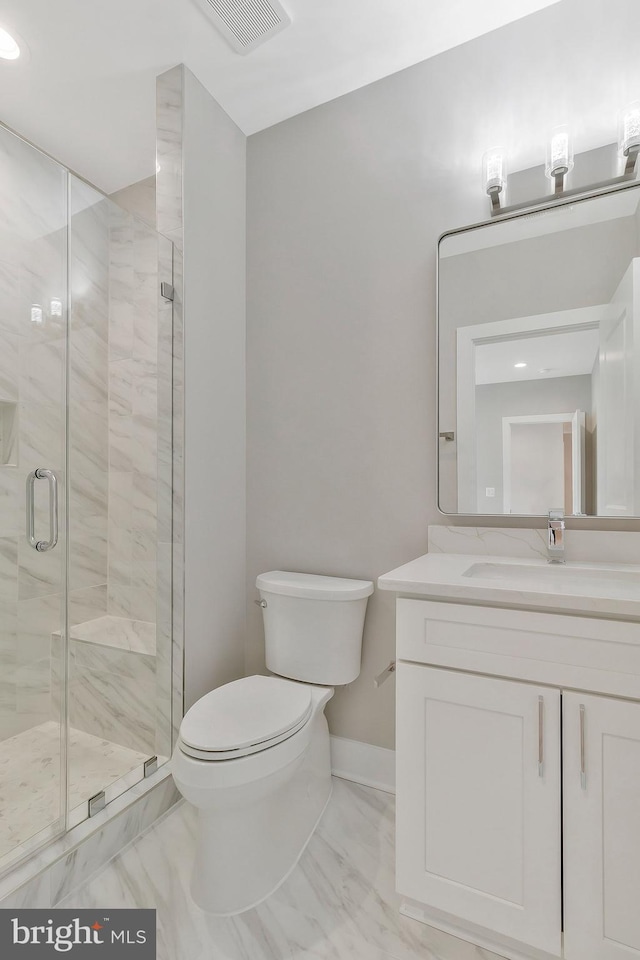 bathroom with toilet, an enclosed shower, and vanity