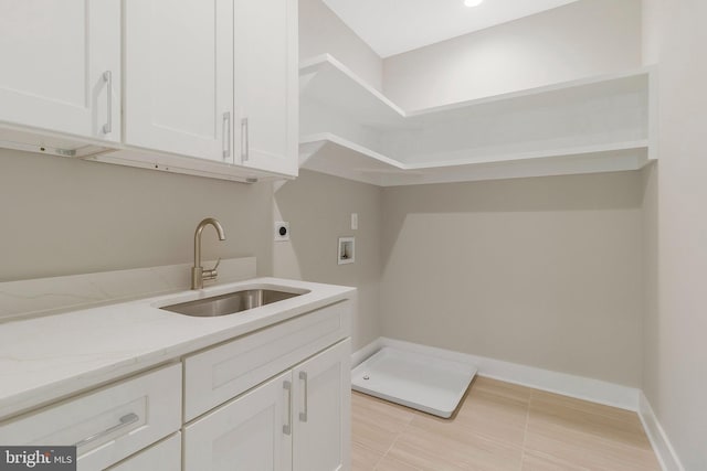 laundry area with sink, hookup for a washing machine, electric dryer hookup, and cabinets