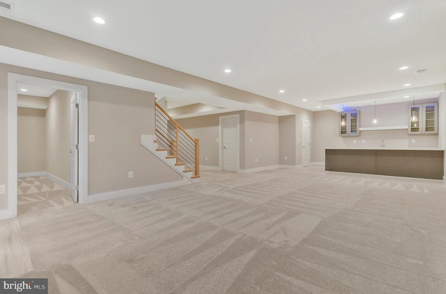 basement with sink and light carpet