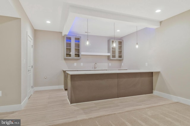 kitchen with sink, kitchen peninsula, hanging light fixtures, and beam ceiling