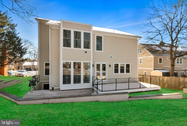 back of house with a patio area, a yard, and french doors