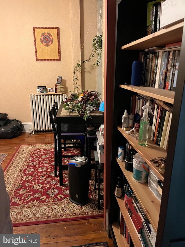 interior space with wood-type flooring and radiator