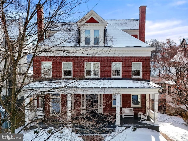 516 Washington St, Cumberland, MD 21502 - view of front facade with brick siding, a porch, and a chimney