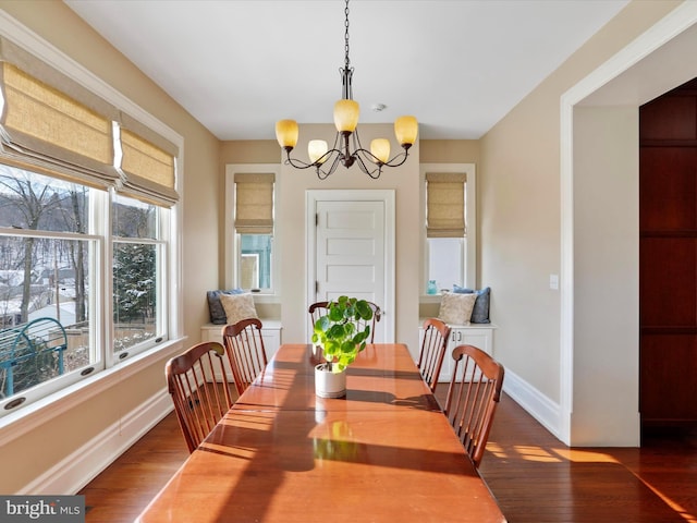 dining space with a chandelier and dark hardwood / wood-style floors