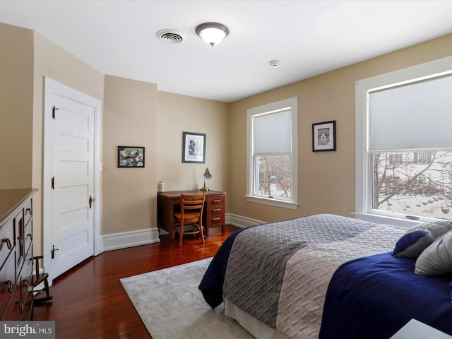 bedroom with dark wood-type flooring