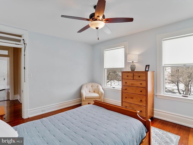 bedroom with ceiling fan and dark hardwood / wood-style flooring