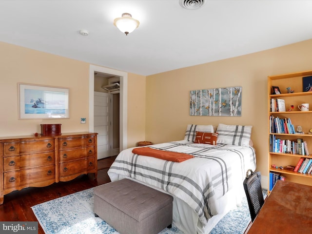 bedroom with a closet and dark hardwood / wood-style flooring