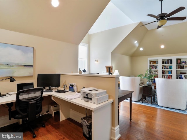 office space with vaulted ceiling, ceiling fan, built in shelves, and dark hardwood / wood-style flooring