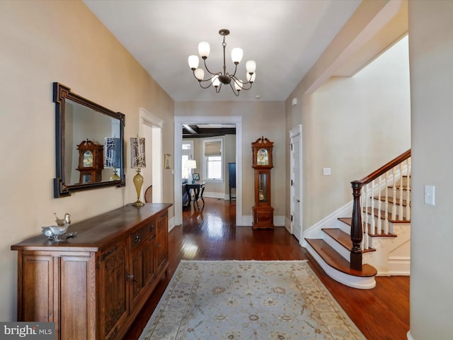 foyer entrance featuring a chandelier and dark hardwood / wood-style flooring