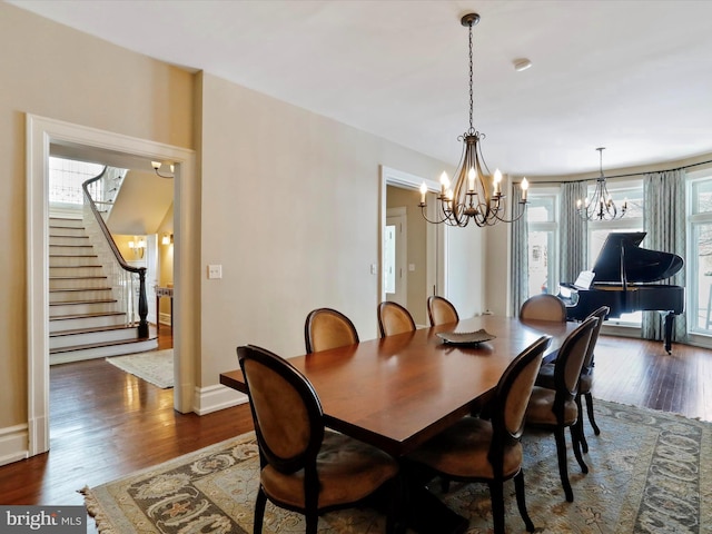 dining room with an inviting chandelier and dark hardwood / wood-style floors