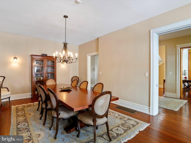 dining room featuring a chandelier and dark hardwood / wood-style flooring