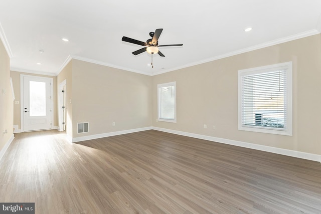 unfurnished living room with crown molding, hardwood / wood-style flooring, and ceiling fan