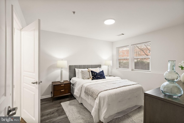 bedroom with dark hardwood / wood-style flooring