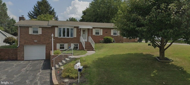 single story home with brick siding, a chimney, asphalt driveway, and a front yard