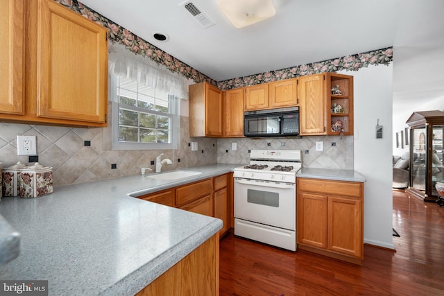 kitchen featuring dark hardwood / wood-style flooring, white gas range, decorative backsplash, and sink