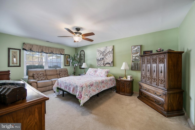 bedroom featuring light carpet and ceiling fan