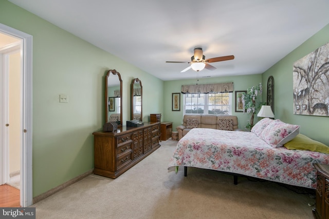 bedroom featuring light carpet and ceiling fan