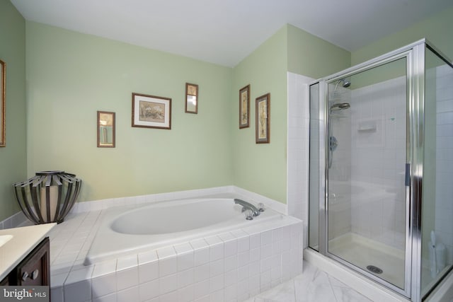 bathroom with vanity and independent shower and bath