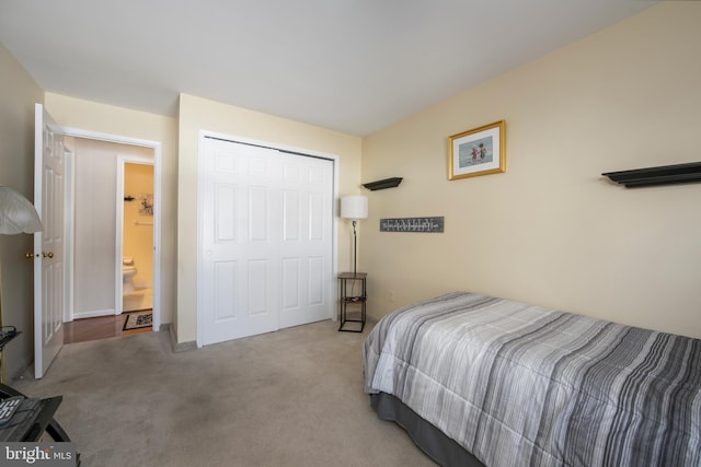 bedroom with light colored carpet and a closet