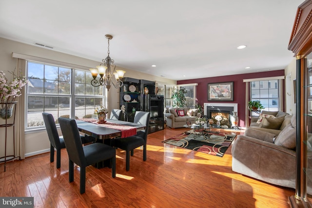 dining room featuring hardwood / wood-style floors and a chandelier