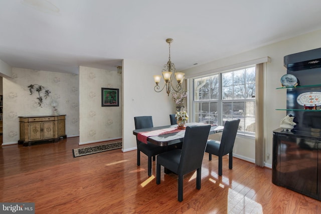 dining space featuring an inviting chandelier and hardwood / wood-style floors