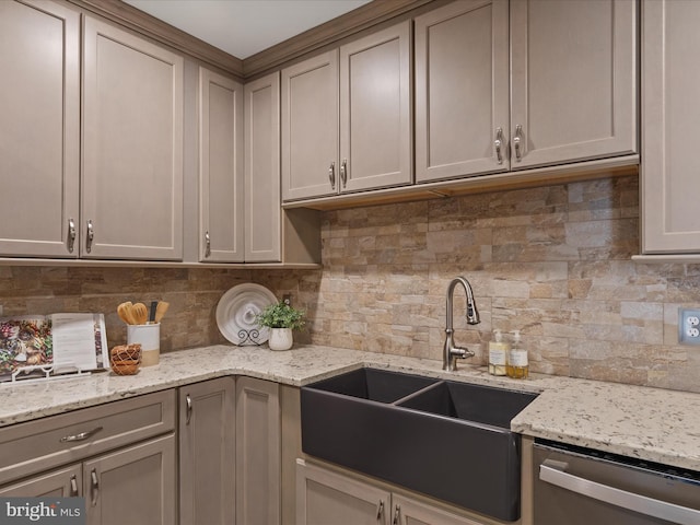 kitchen with dishwasher, sink, backsplash, gray cabinetry, and light stone countertops