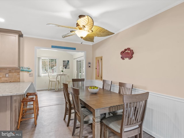 dining area featuring ceiling fan, hardwood / wood-style floors, and crown molding