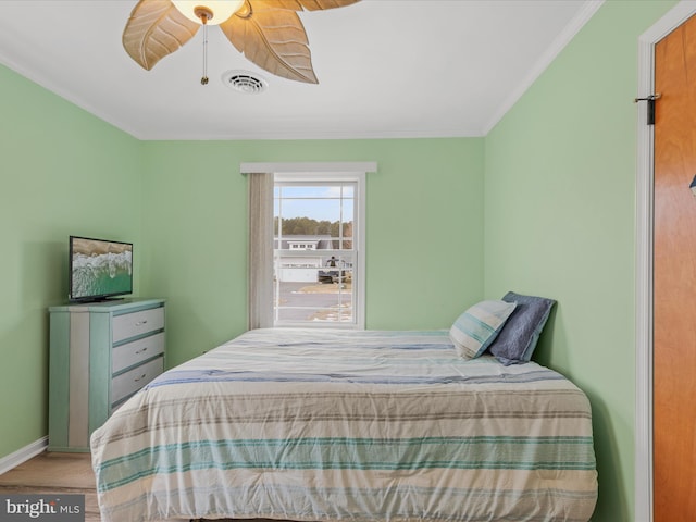 bedroom with ceiling fan and wood-type flooring