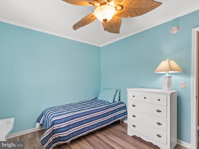 bedroom with ceiling fan, ornamental molding, and light wood-type flooring