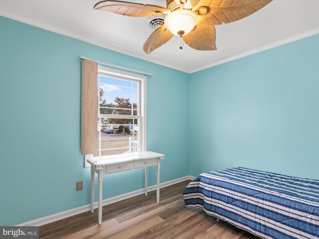 bedroom featuring ceiling fan, crown molding, and wood-type flooring