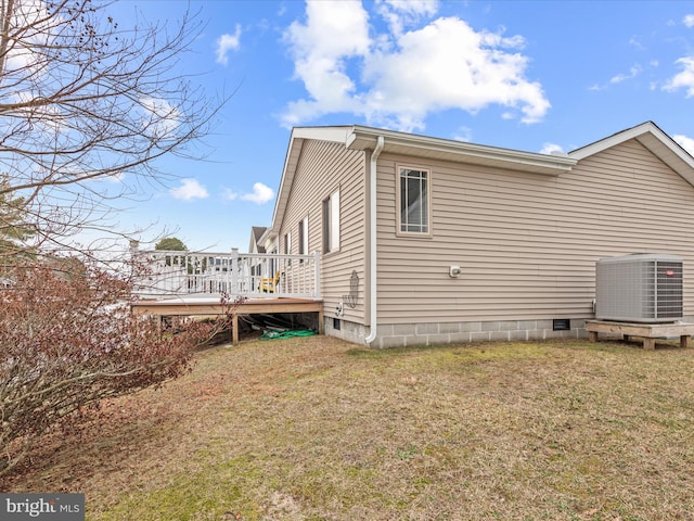 view of side of home with cooling unit, a deck, and a lawn