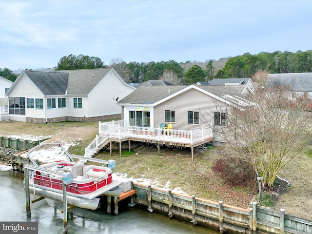 back of house featuring a deck with water view