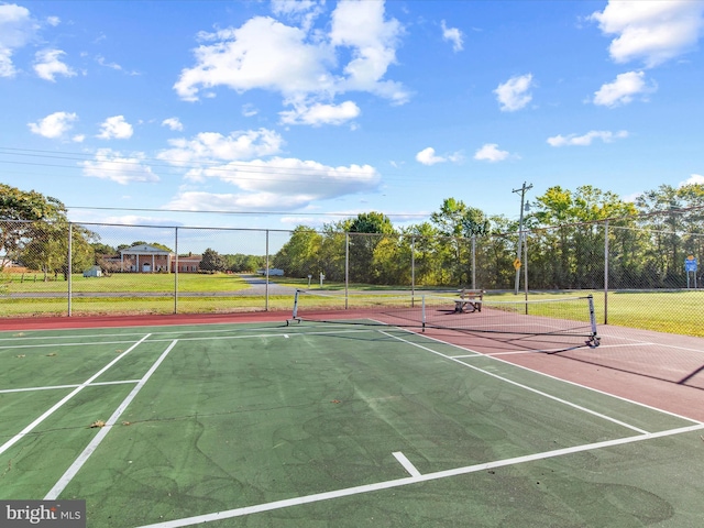 view of tennis court with basketball hoop