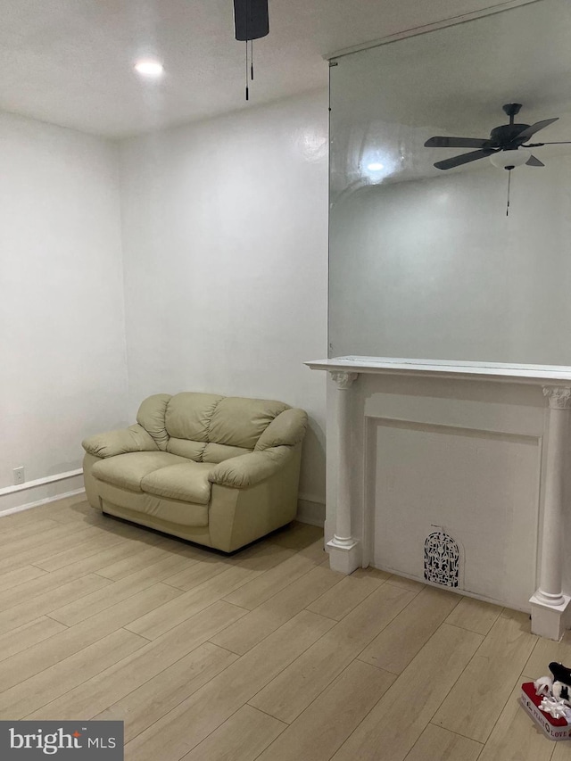 living area featuring ceiling fan and light hardwood / wood-style floors