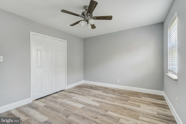 unfurnished bedroom with a closet, ceiling fan, and light hardwood / wood-style flooring