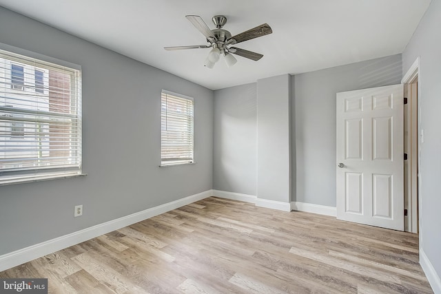 empty room featuring ceiling fan and light wood-type flooring