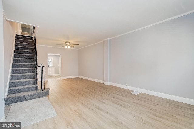 unfurnished living room with ceiling fan, ornamental molding, and light hardwood / wood-style floors