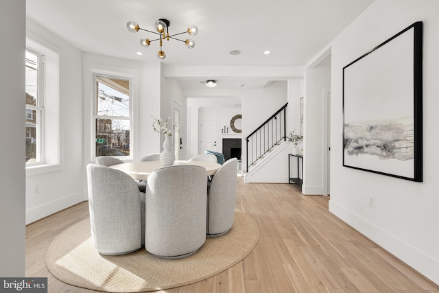 dining area featuring a chandelier and light wood-type flooring