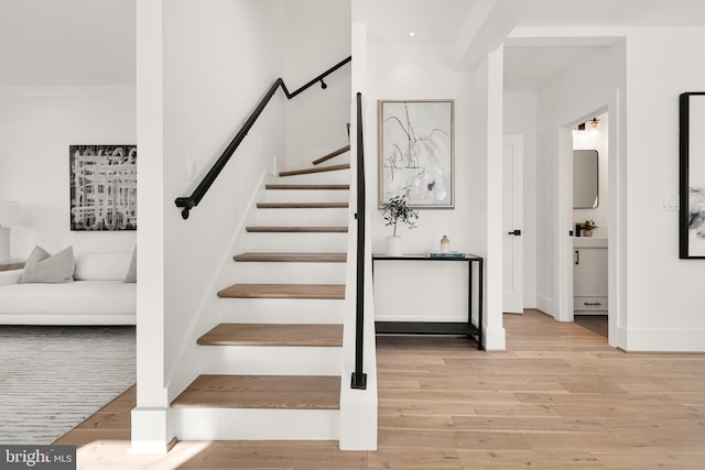 staircase with hardwood / wood-style floors