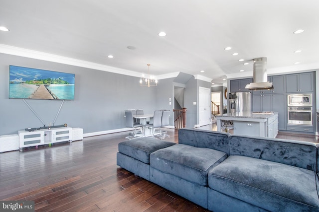 living room featuring crown molding, a notable chandelier, and dark hardwood / wood-style flooring