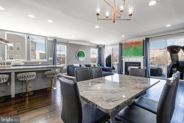 dining area with crown molding and dark wood-type flooring