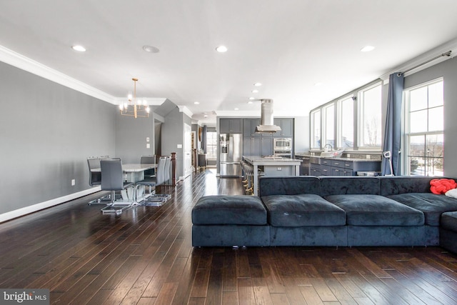 living room featuring ornamental molding, a healthy amount of sunlight, and dark hardwood / wood-style flooring