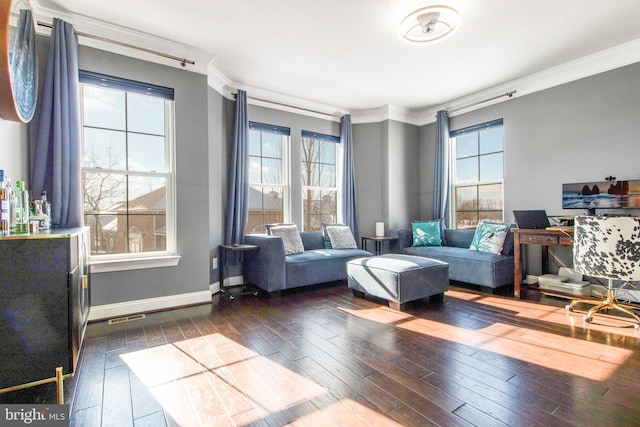 living room featuring a healthy amount of sunlight, dark wood-type flooring, and ornamental molding