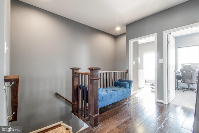 hallway with dark hardwood / wood-style flooring