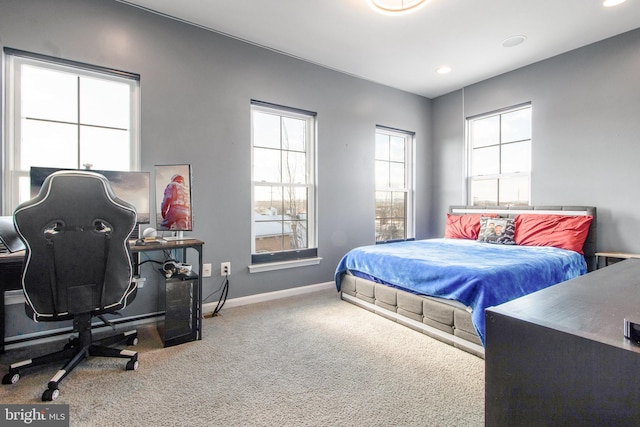 bedroom featuring multiple windows and carpet