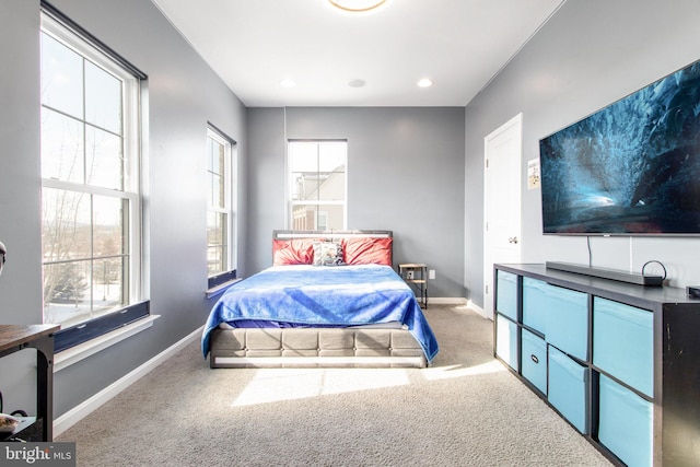 bedroom with multiple windows and carpet flooring