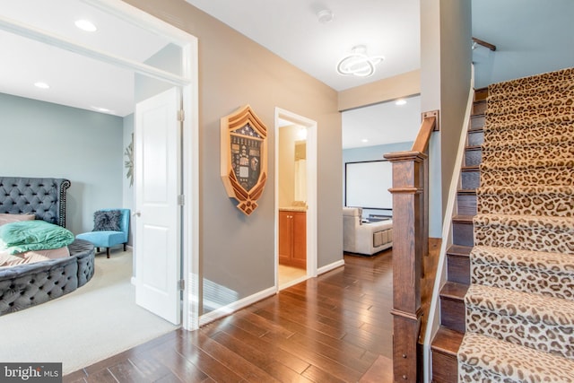 stairway with hardwood / wood-style flooring