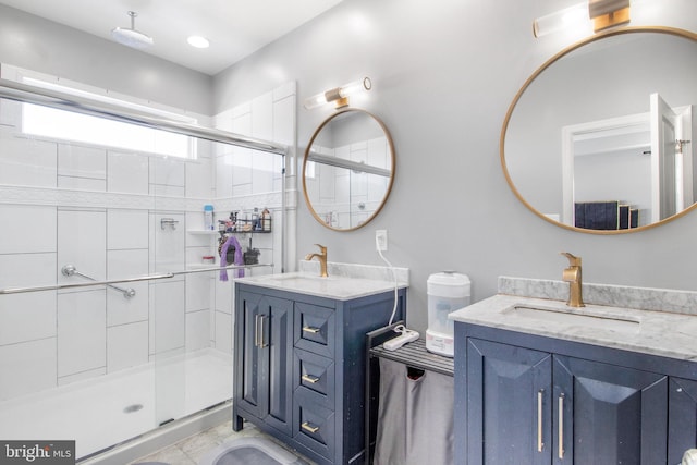 bathroom with a shower with door and vanity